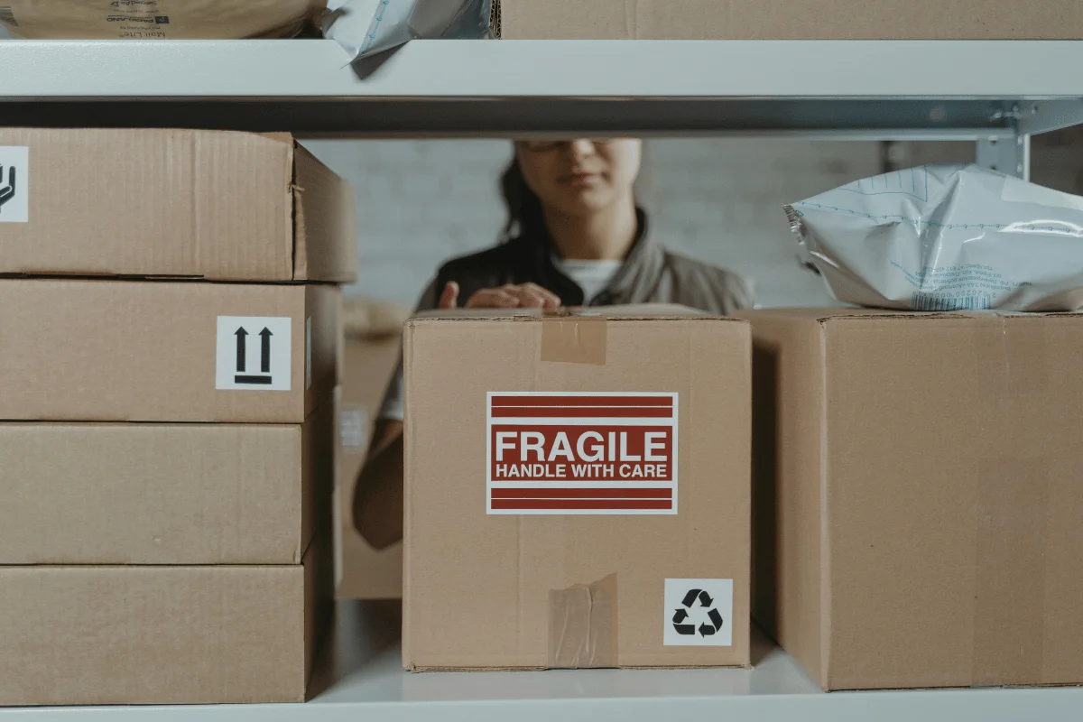 Warehouse storage scene with prominently labeled fragile boxes.