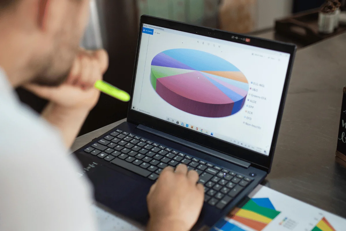 Analyzing a colorful pie chart displayed on a laptop screen for data visualization and decision-making.